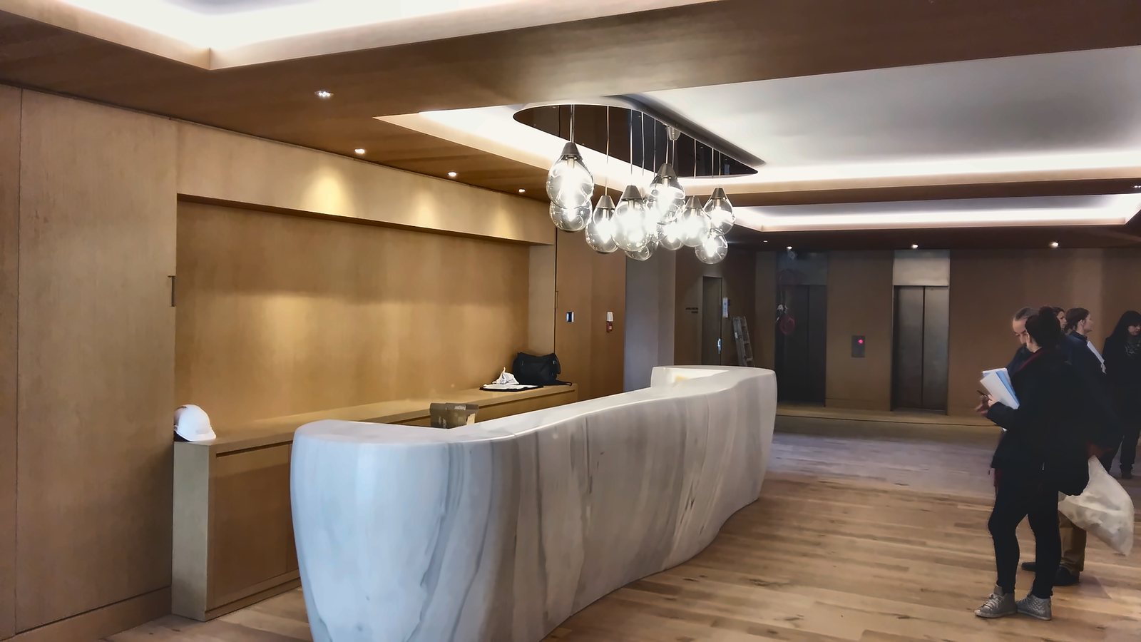 The Alpine Spa marble reception desk, under the cluster of glass drops