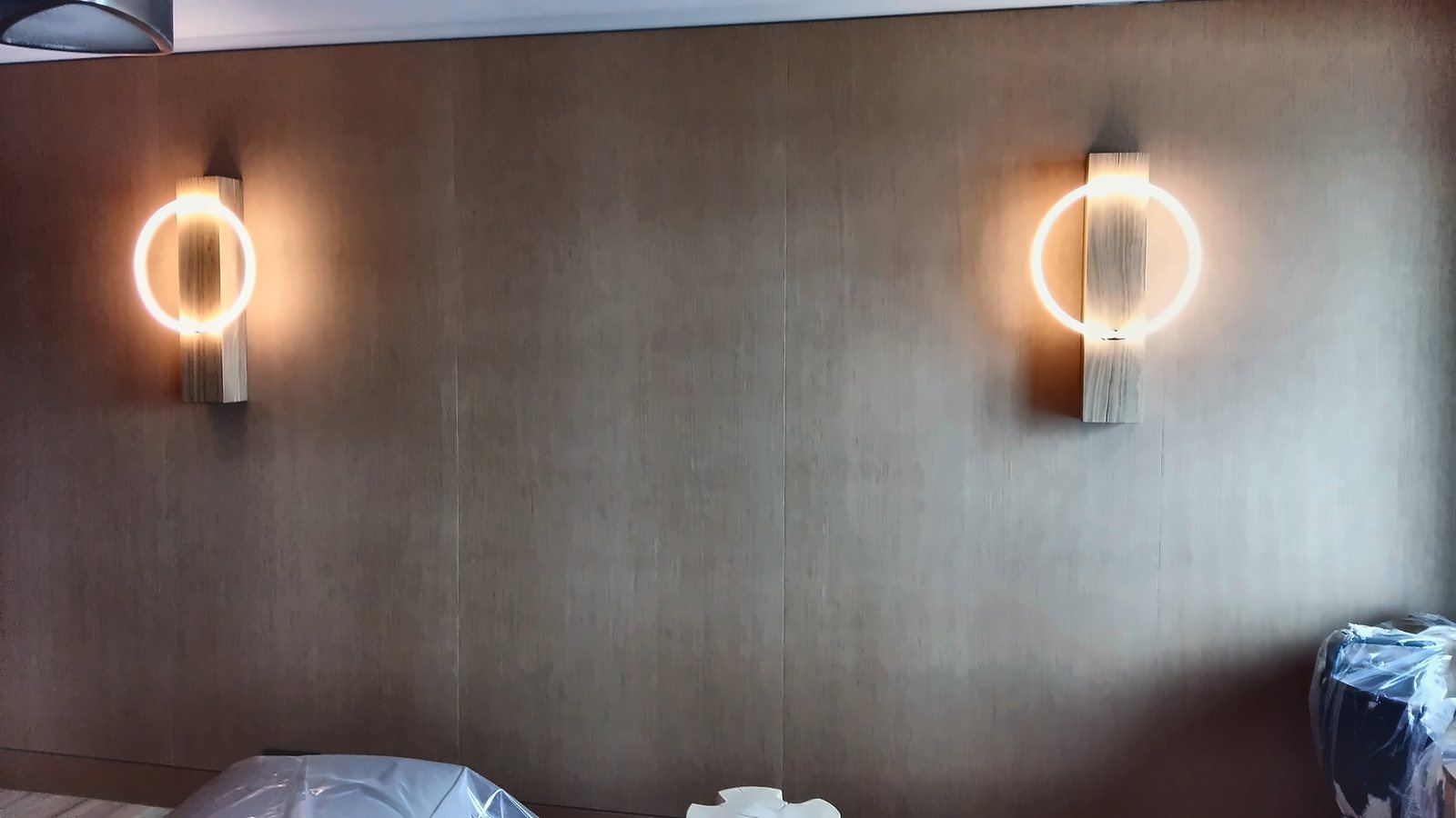 Two glowing-ring wall lights on an Alpine Spa wall