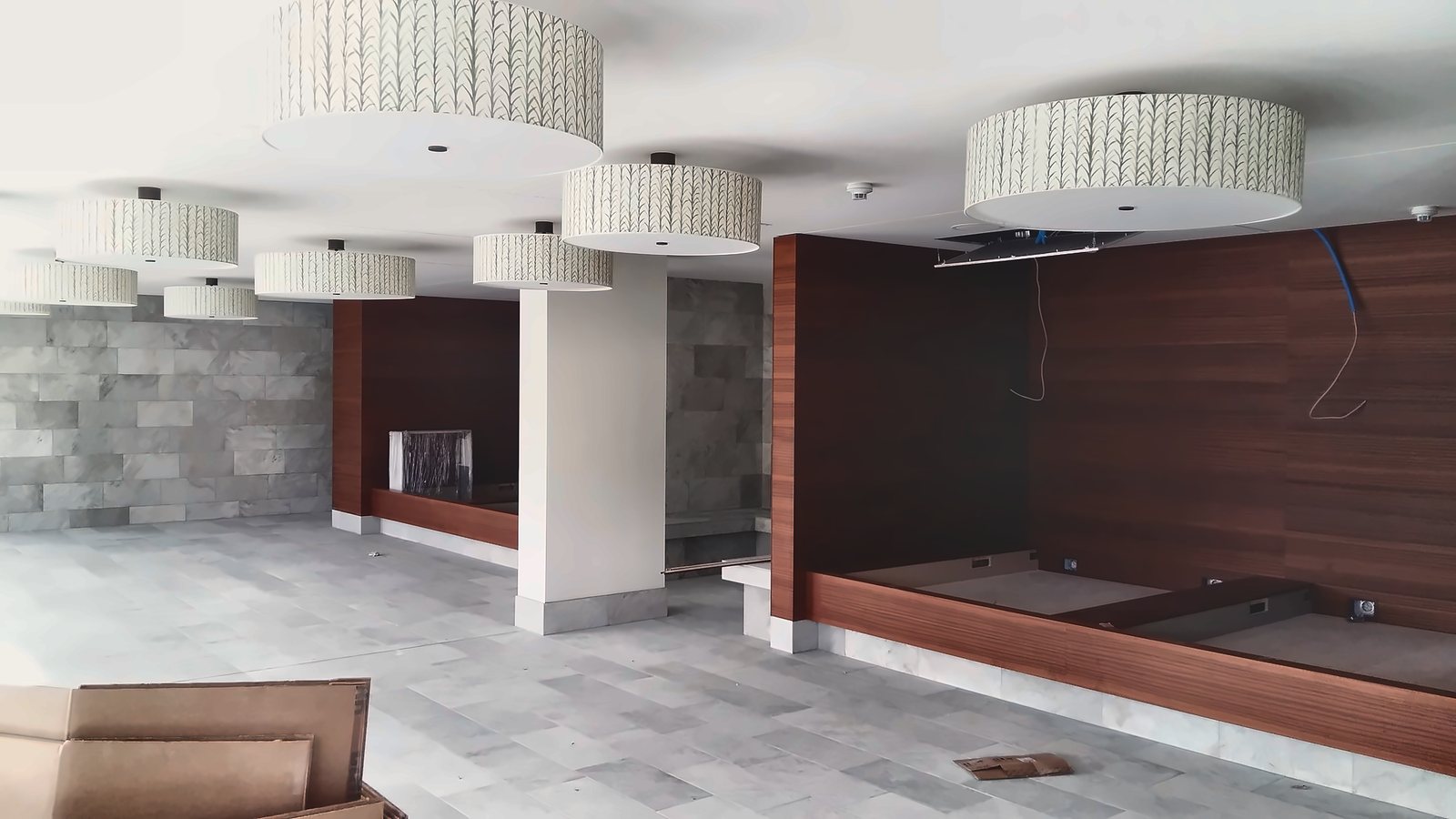 The lobby with suspended fabric drums and the timber wall