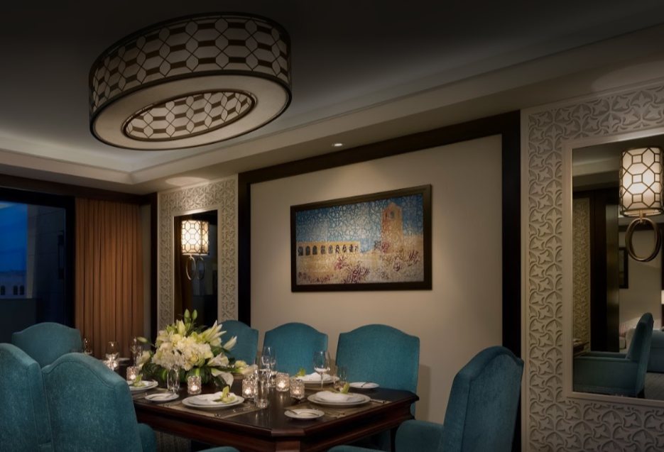 The private dining room with turquoise seating and the perforated drum fitting above the table