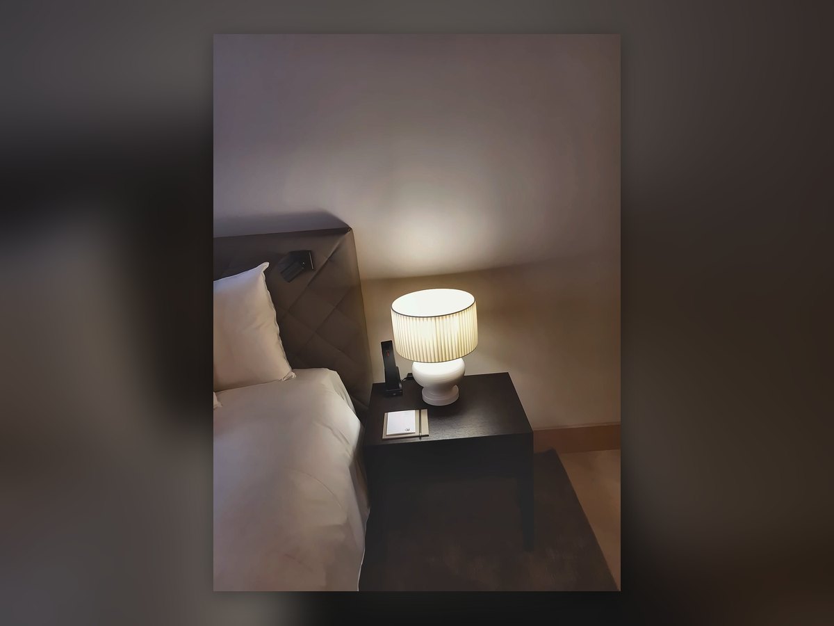 Reading light on the padded headboard of a Waldhotel room