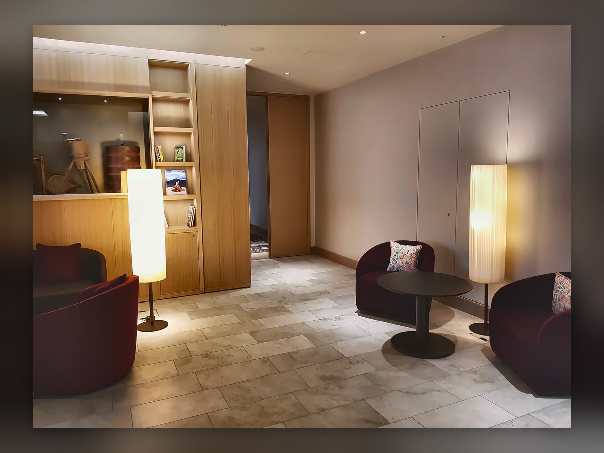 Living area of a Waldhotel Bürgenstock suite with two column floor lamps