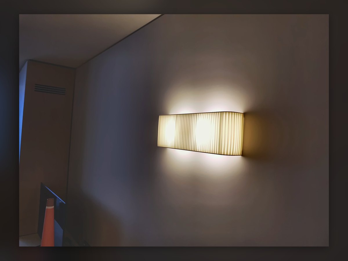 Rectangular pleated fabric wall light on a Waldhotel wall