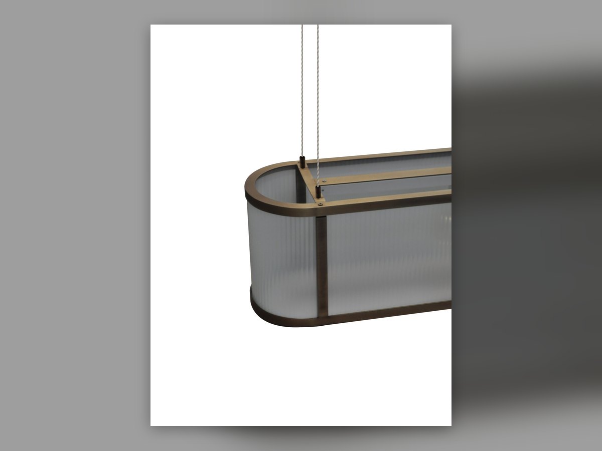 The curved end of the oval fitting seen at three quarters, with the fluted glass following the bend