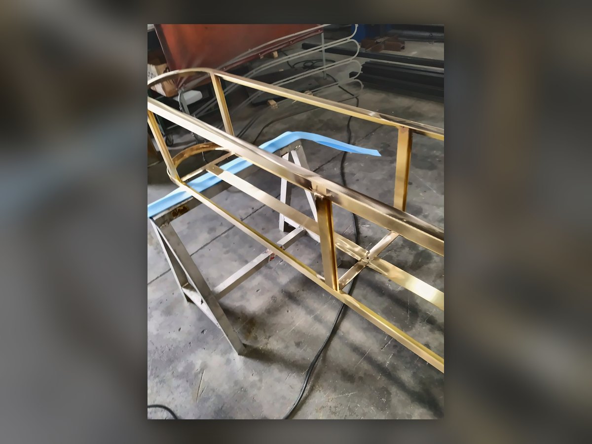 The complete brass frame, assembled in the workshop before the glass goes in