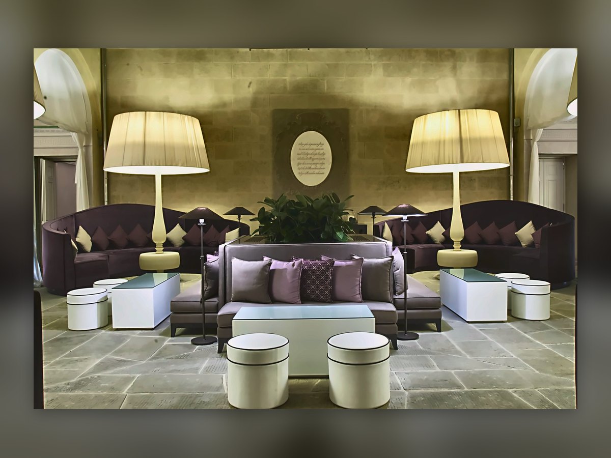The Villa Le Maschere lounge with two monumental floor lamps behind the sofas