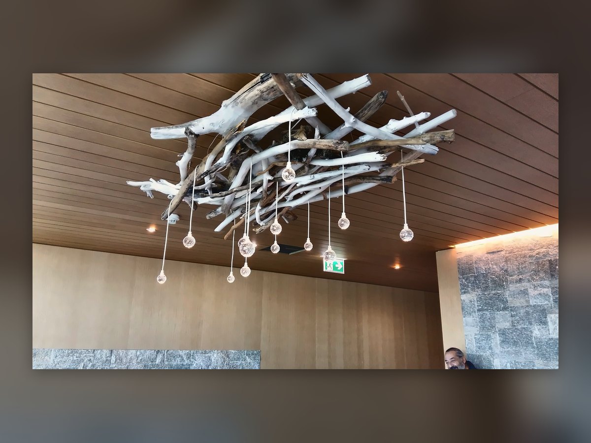 The drop cluster seen from below: white branches and glass drops hanging at different heights