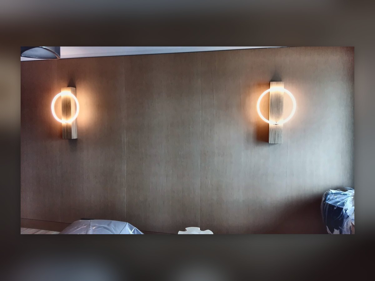 Two glowing-ring wall lights on an Alpine Spa wall