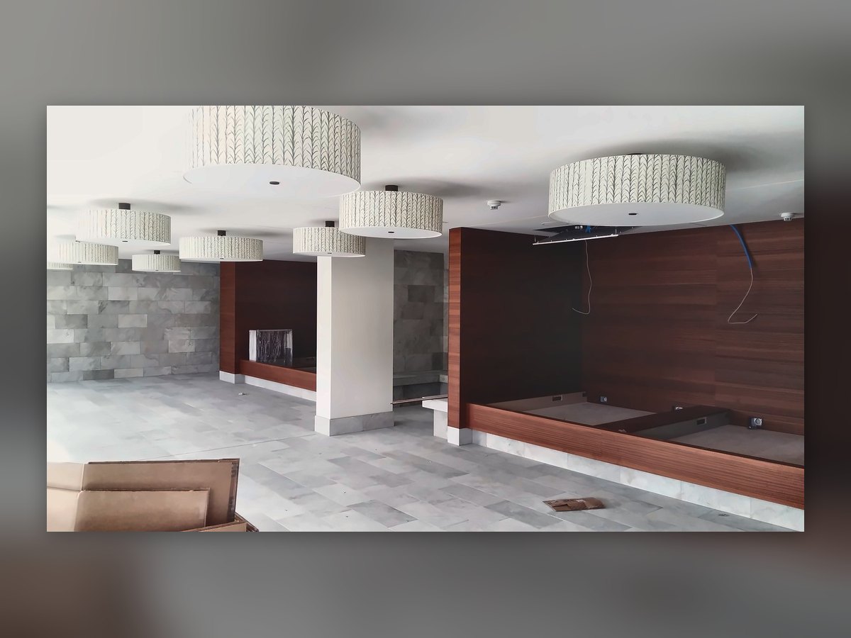 The lobby with suspended fabric drums and the timber wall