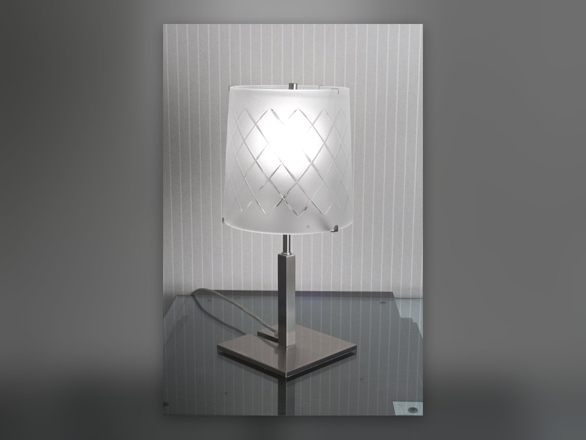 The table lamp lit, its diamond-etched glass reading through the light