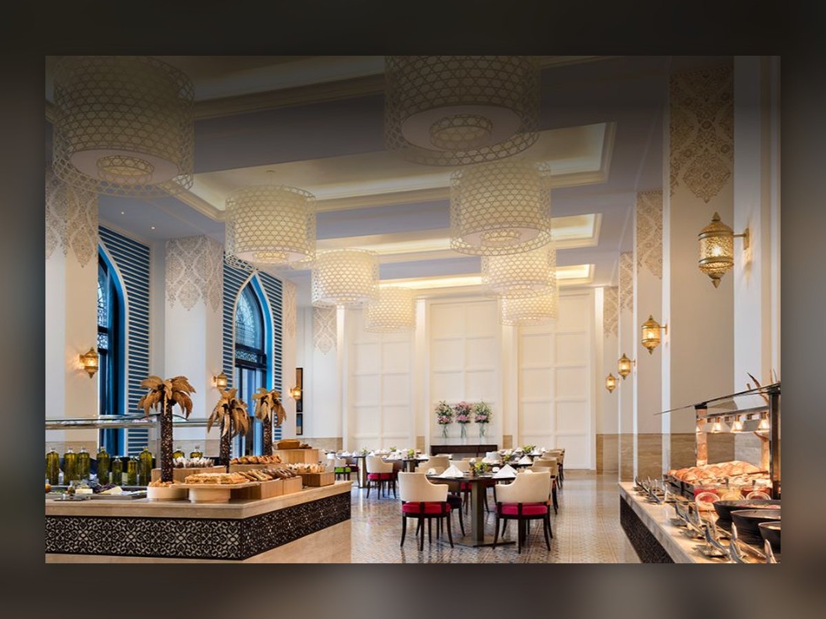 The breakfast room, lanterns hung beneath the arches and the buffet in the foreground