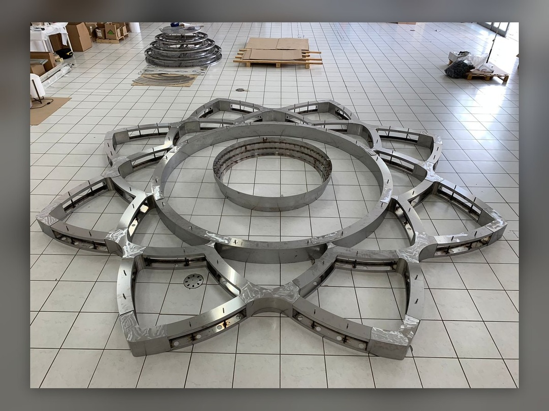 The eight-pointed star in raw steel, dry-assembled on the workshop floor