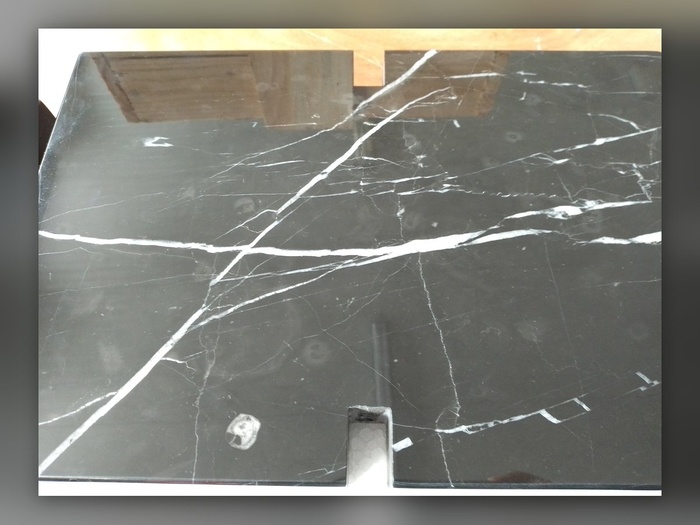 The detail of a milled recess in black marble