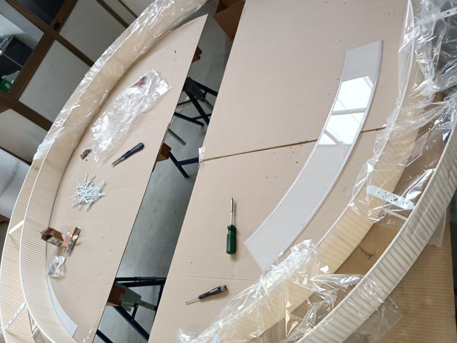 Sections of a large-diameter EVA shade being assembled on the bench