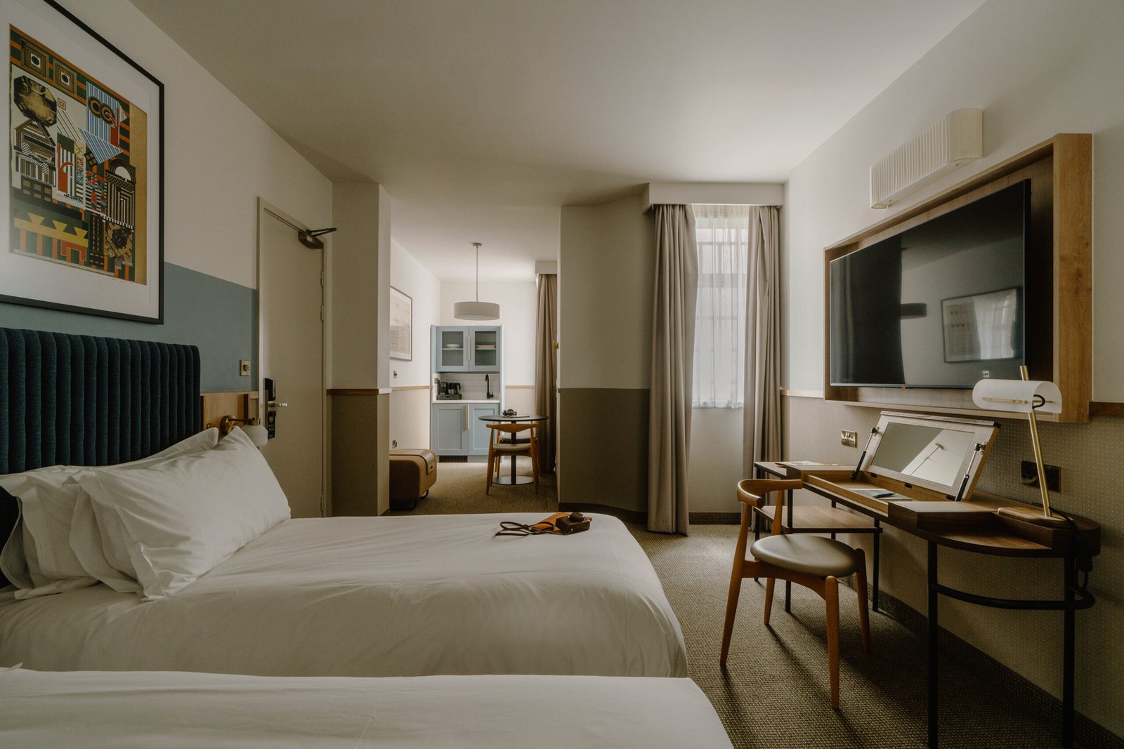 Twin Superior room at Club Quarters London City: E12 pleated fabric wall light above the wooden TV frame