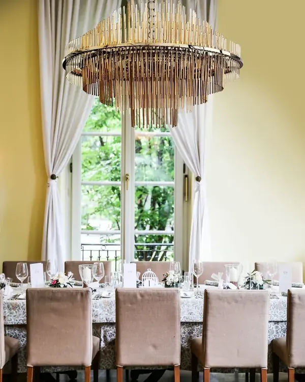 Bespoke chandelier above a laid dining table